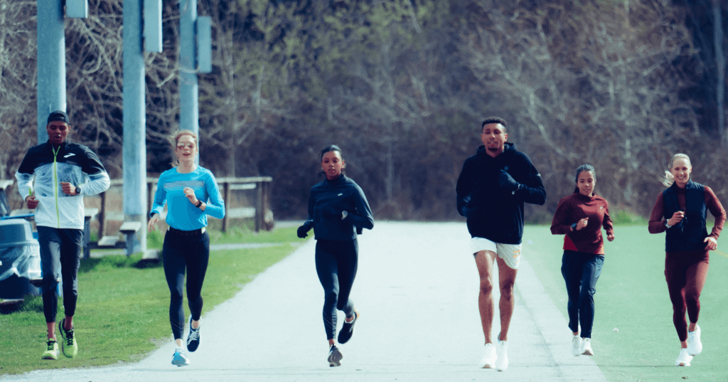 A photo of the Brooks Beasts Track Club members running down the street. An example of athletes that should prioritize their oxygen availability. 